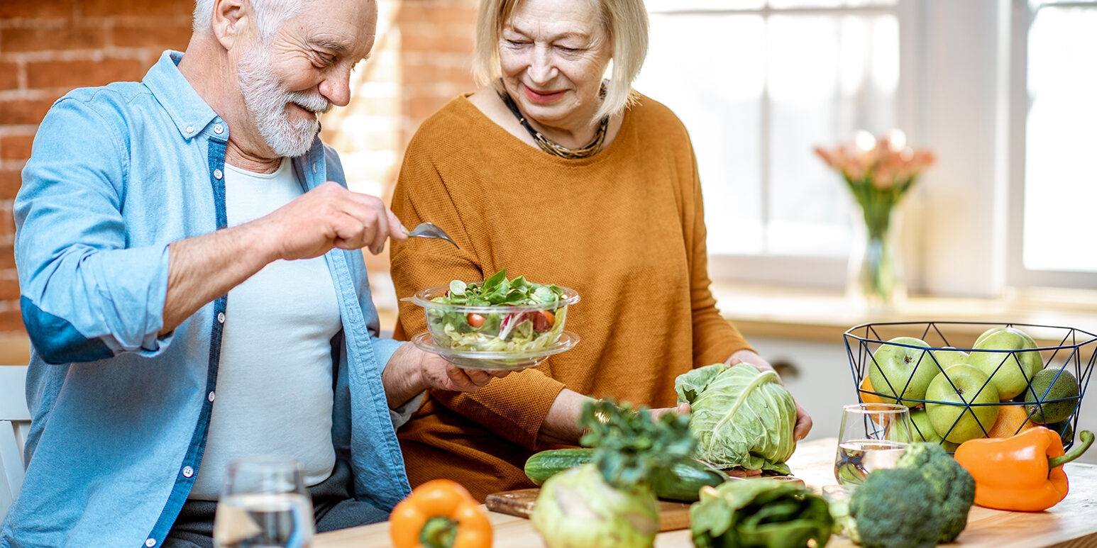 Senior couple with healthy food at home