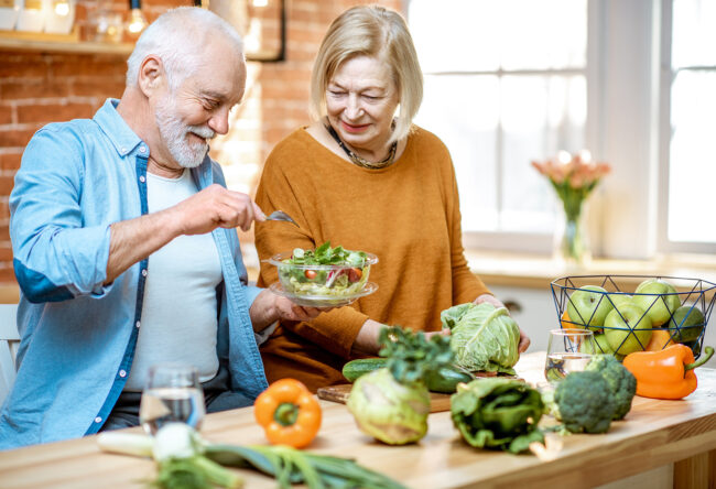 Senior couple with healthy food at home