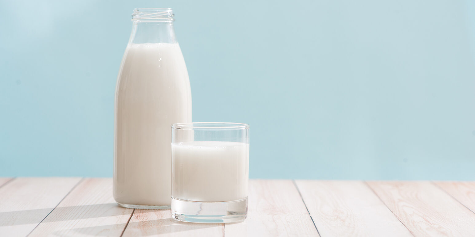 Dairy products. Bottle with milk and glass of milk on wooden table