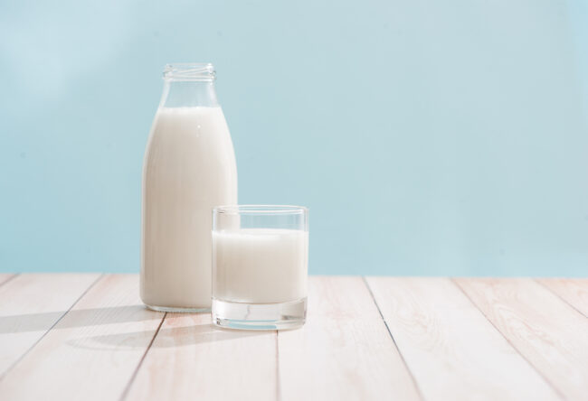 Dairy products. Bottle with milk and glass of milk on wooden table