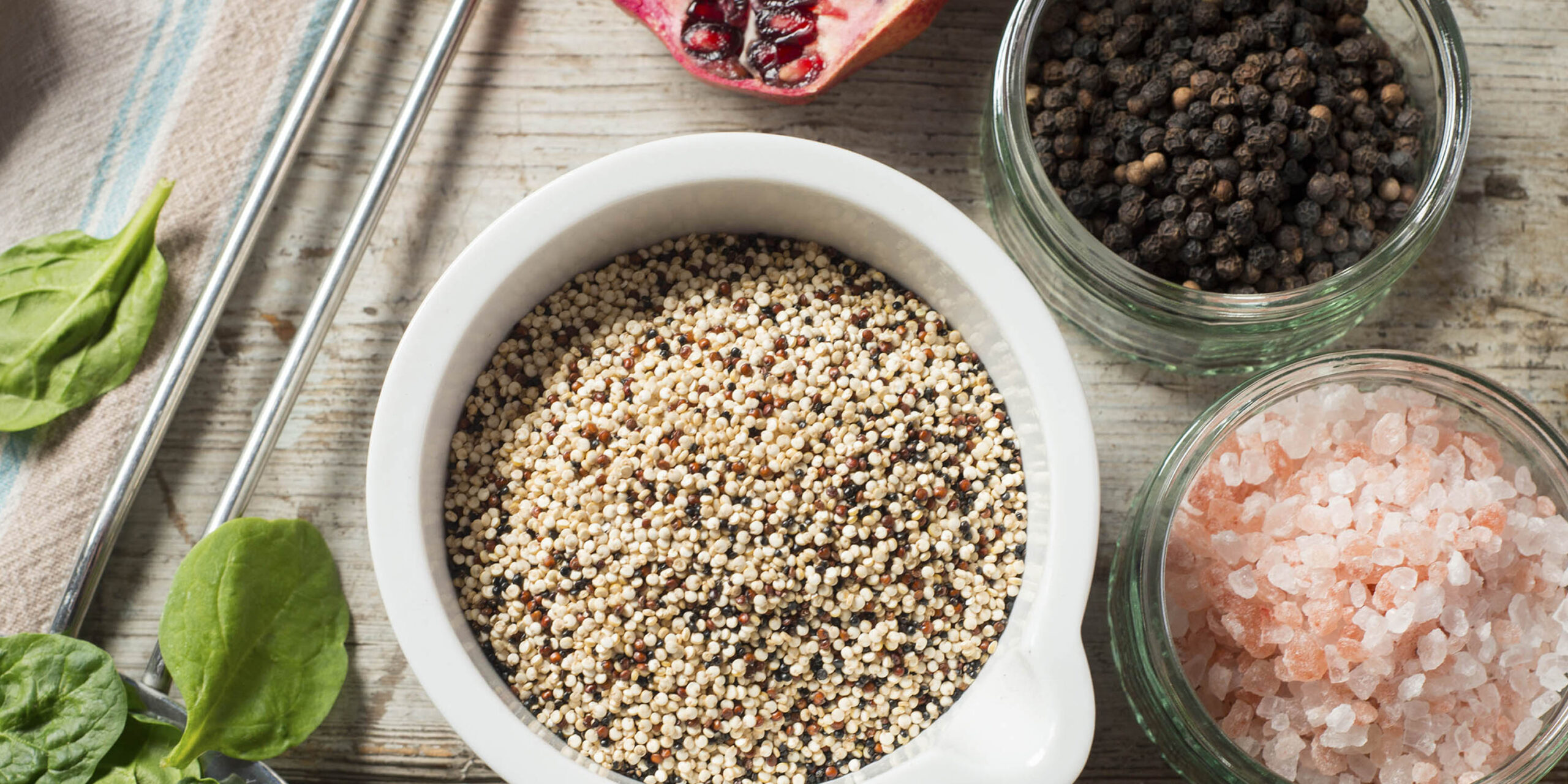 Bowl of Quinoa Alongside Spinach and Other Spices