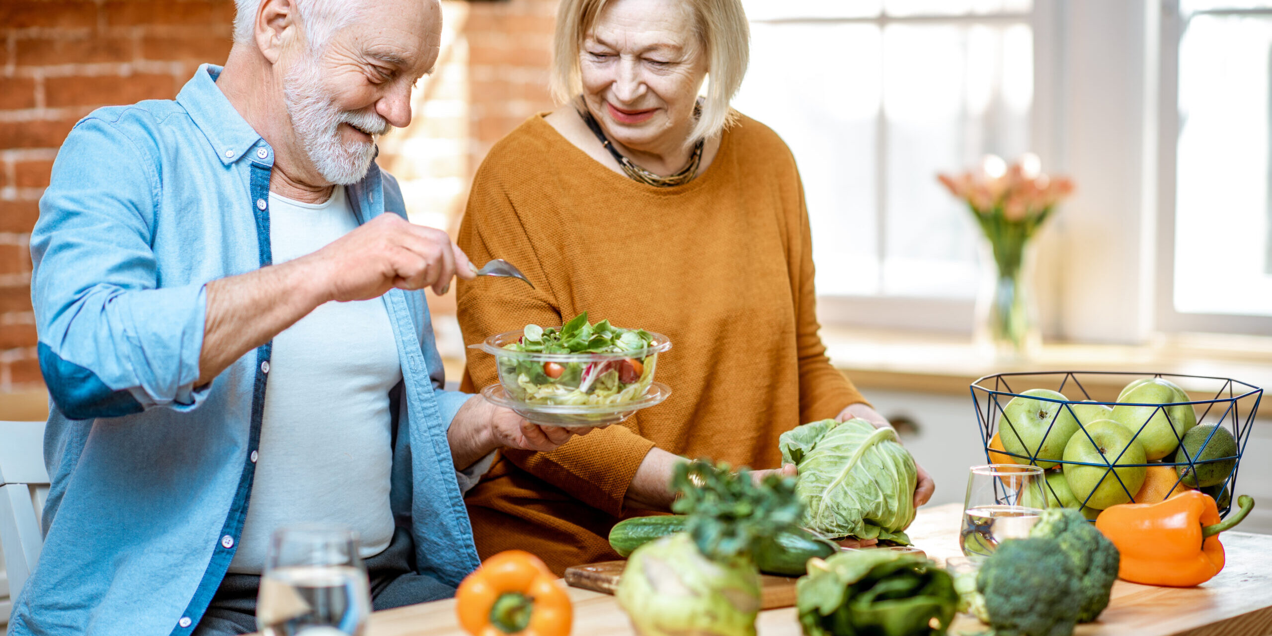 Senior couple with healthy food at home