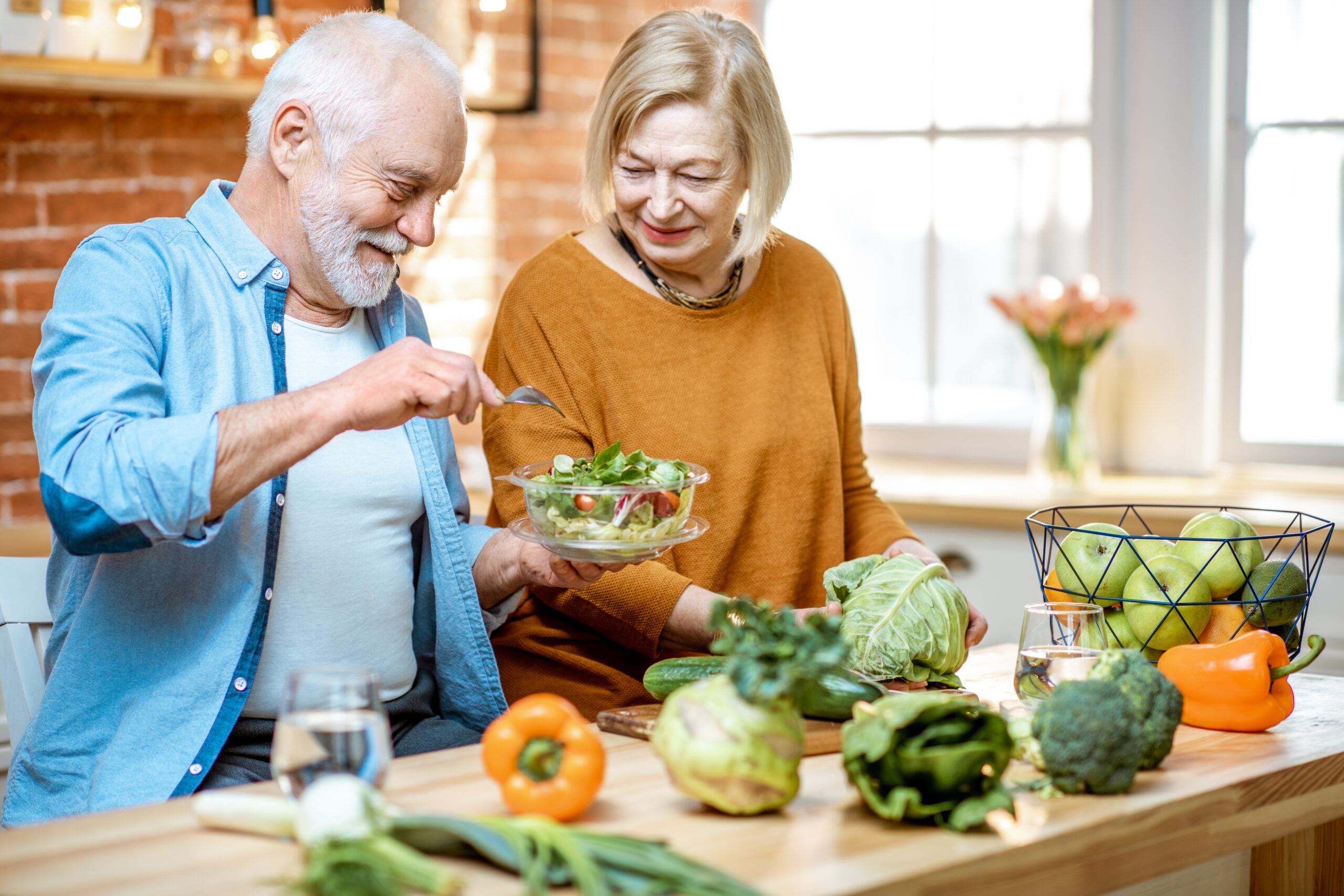 Senior couple with healthy food at home