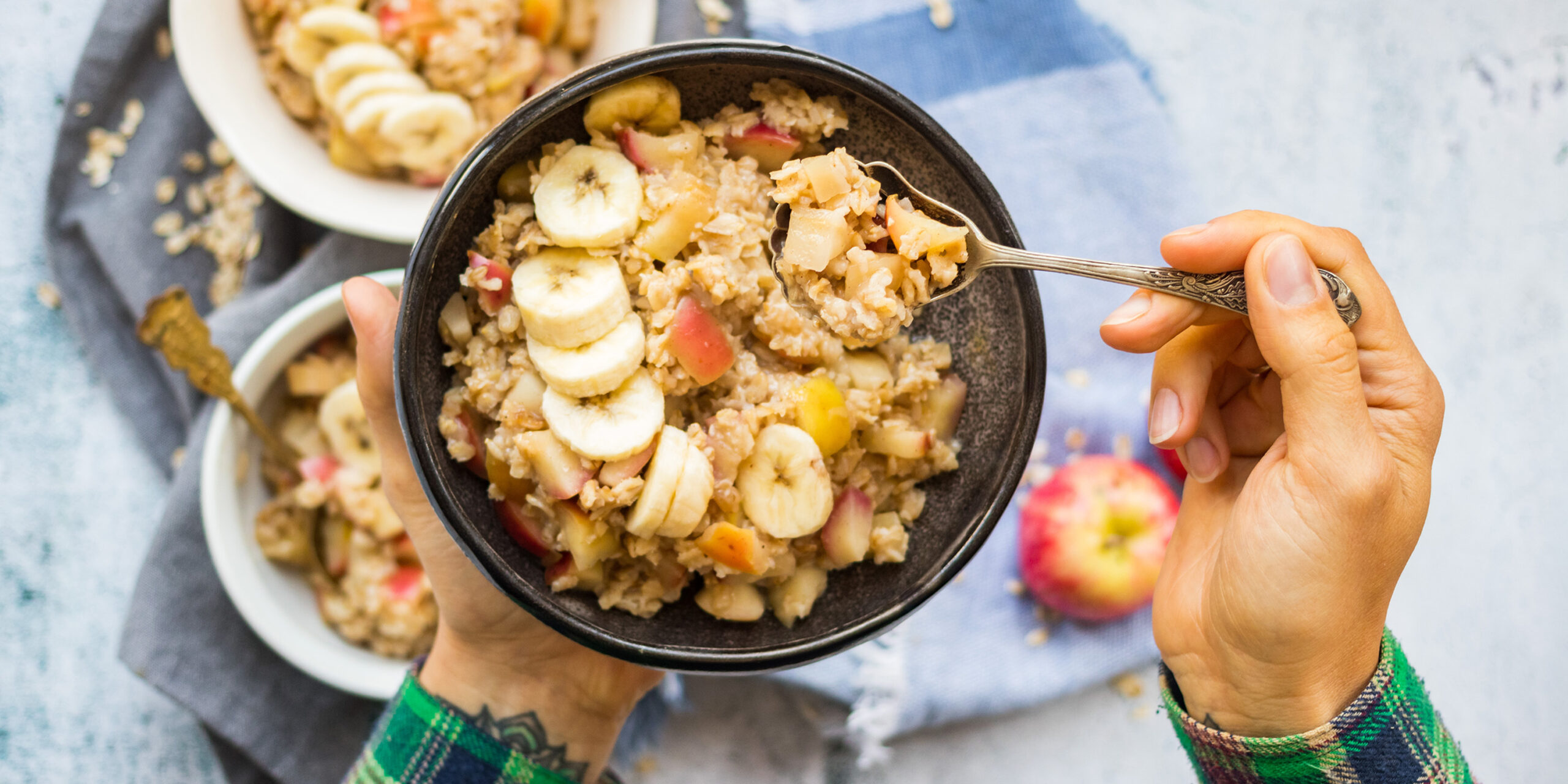 Oatmeal granola porridge with apple and banana fruits and nuts.