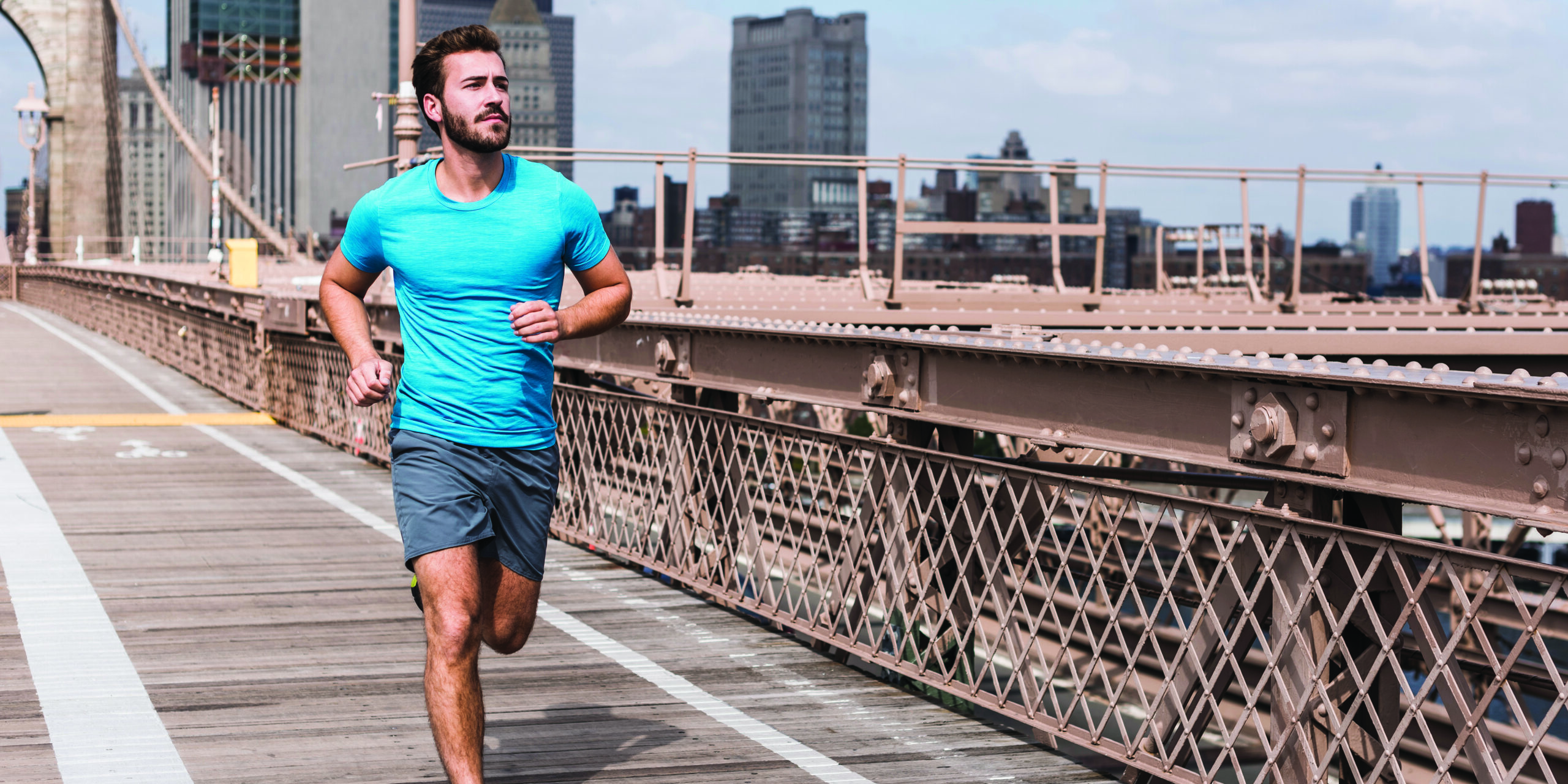 USA, New York City, man running on Brooklyn Brige
