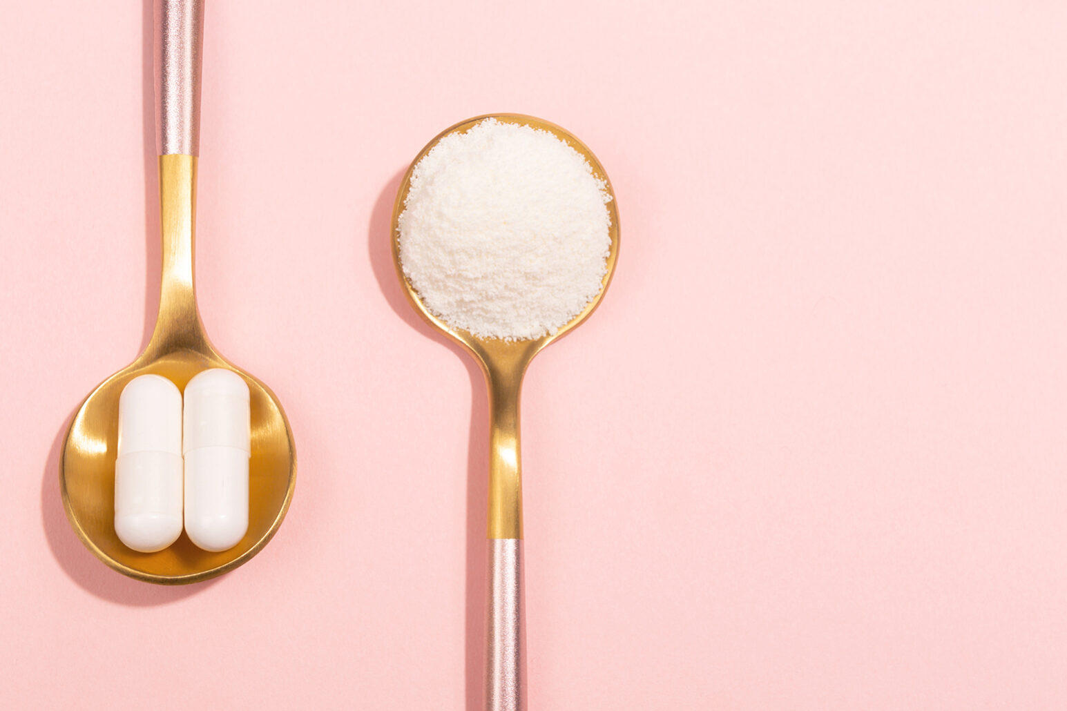 Collagen powder and pills on pink background