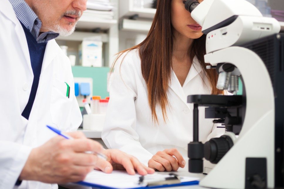 Research, COVID Antibody Testing Researchers in a lab looking through a microscope