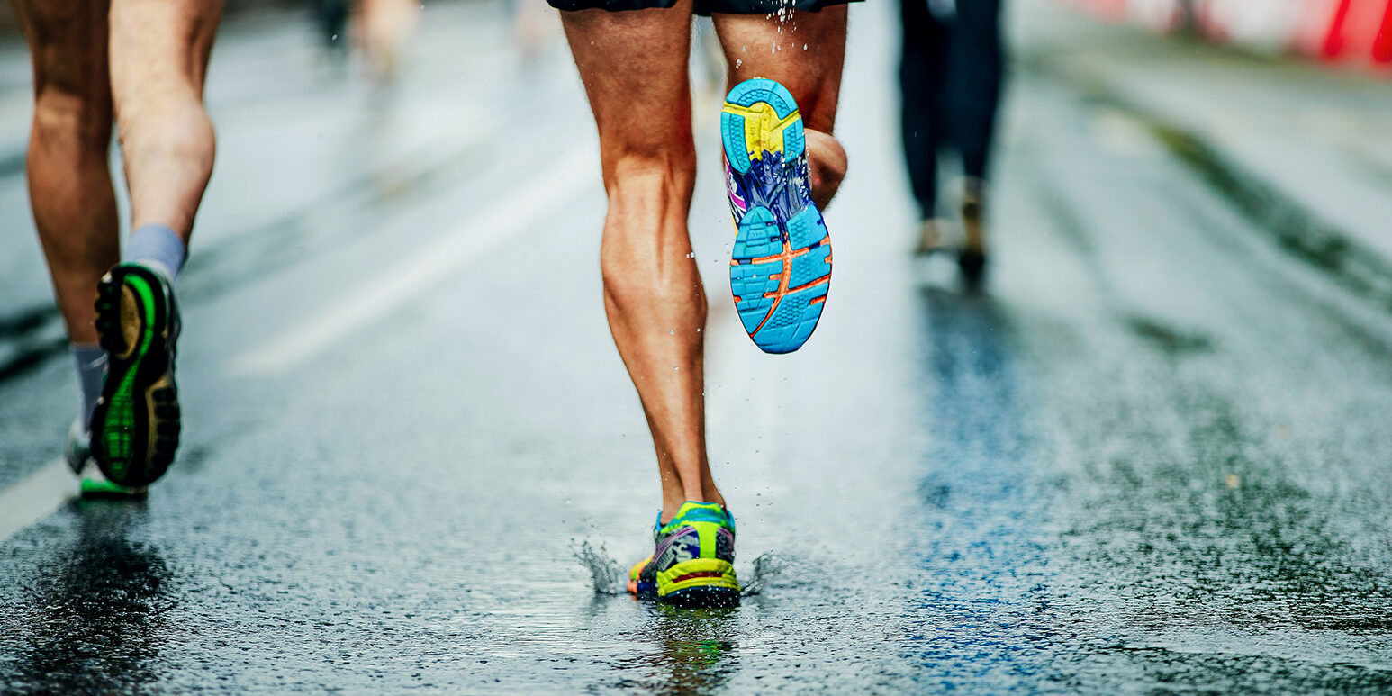 water sprays from under running shoes