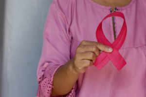 Woman holding a pink ribbon