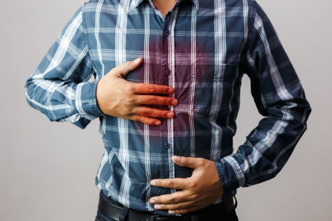 Man experiencing reflux or heartburn