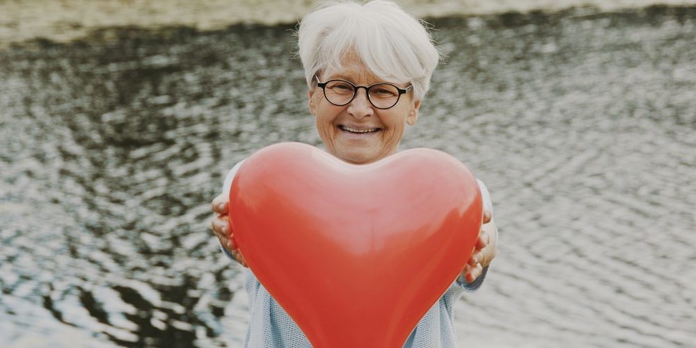 Heart disease and dementia Woman holding heart-shaped balloon