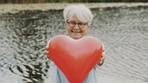 Woman holding heart-shaped balloon