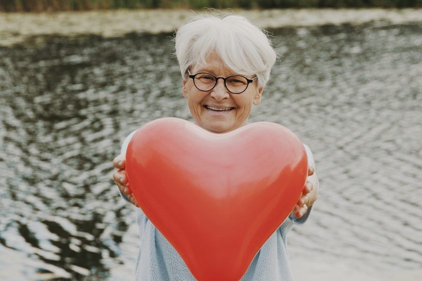 Heart disease and dementia Woman holding heart-shaped balloon