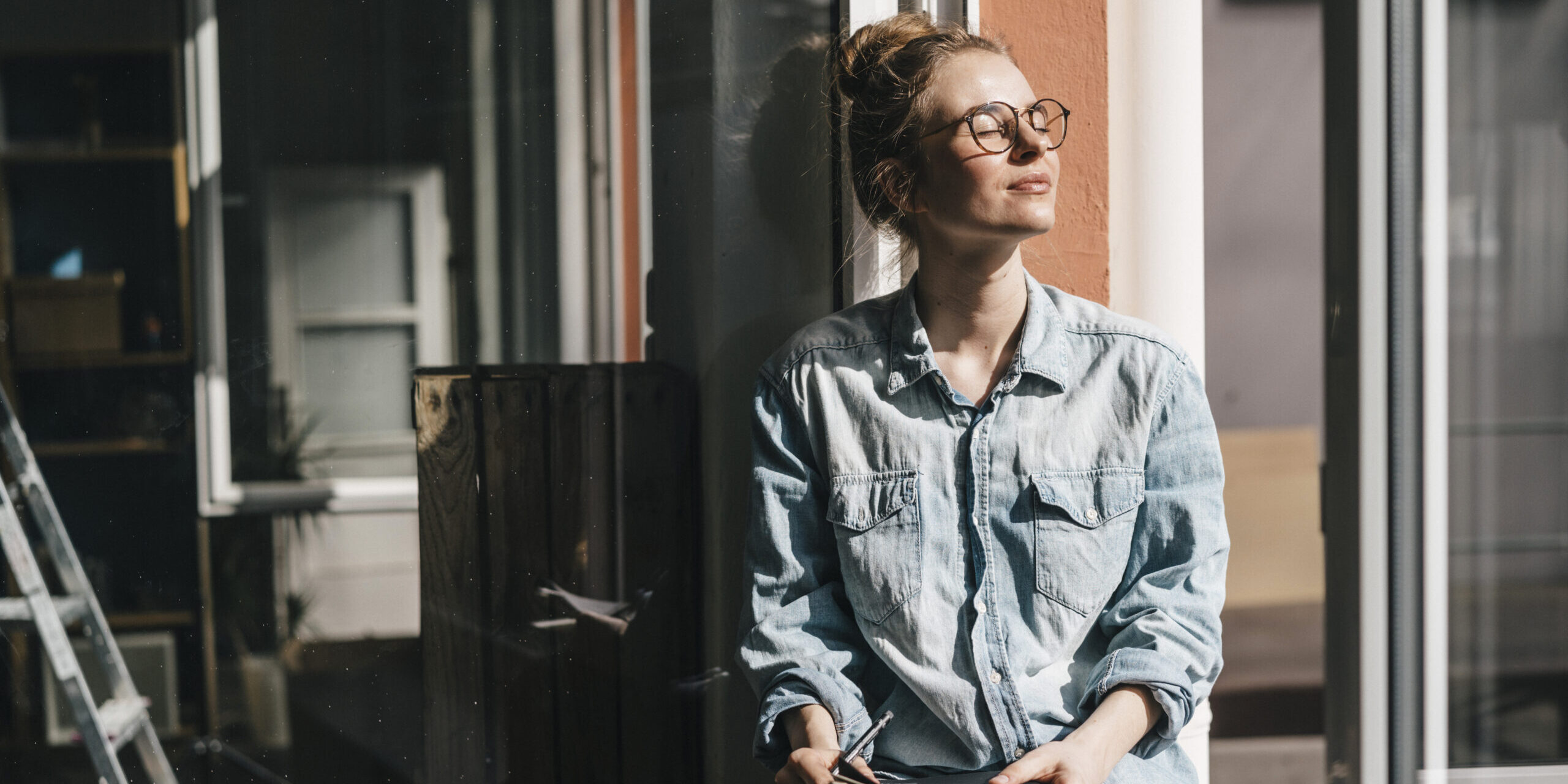 Young woman with glasses in sunlight