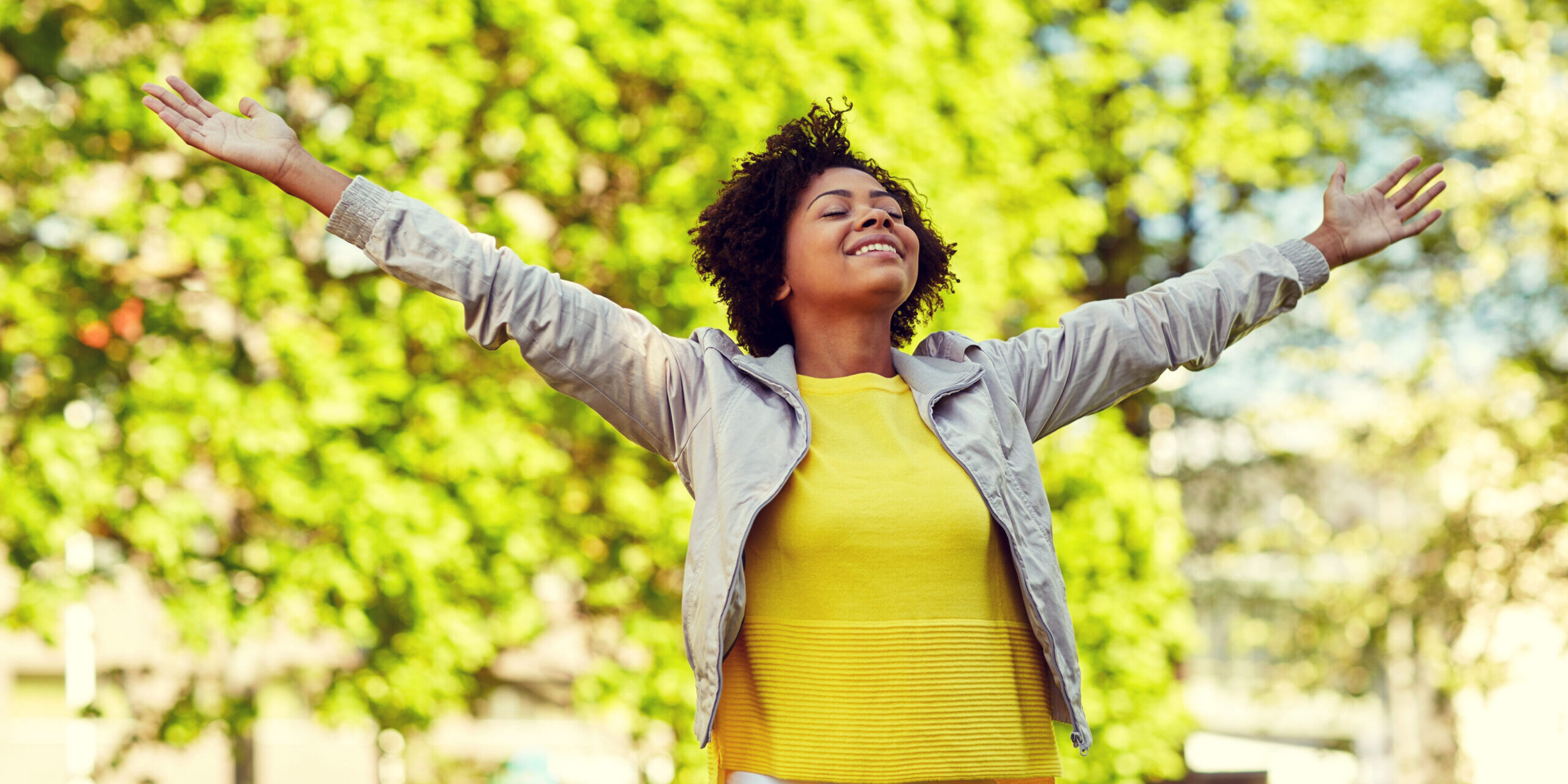 happy african american young woman in summer park
