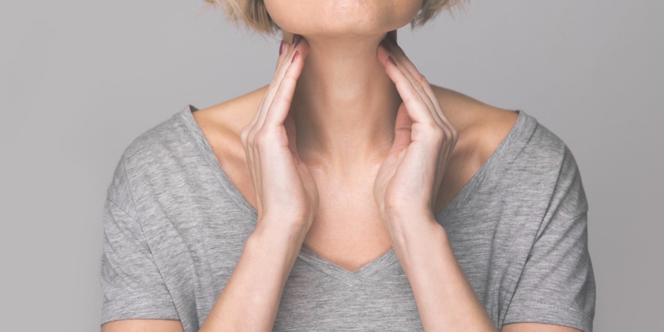 Maybe it’s your thyroid Woman feeling her neck, checking thyroid