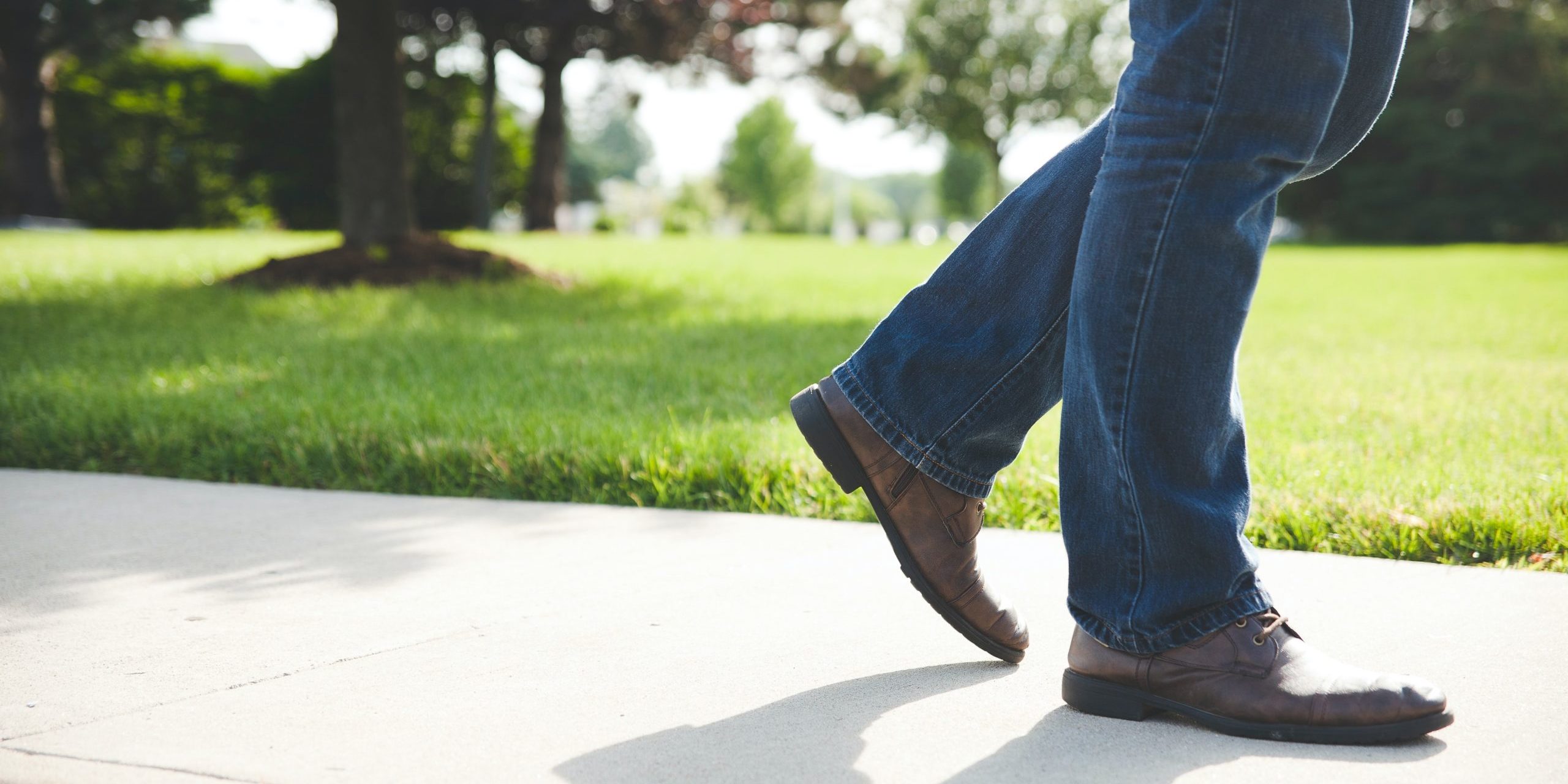 Close up of shoed feet walking down side walk