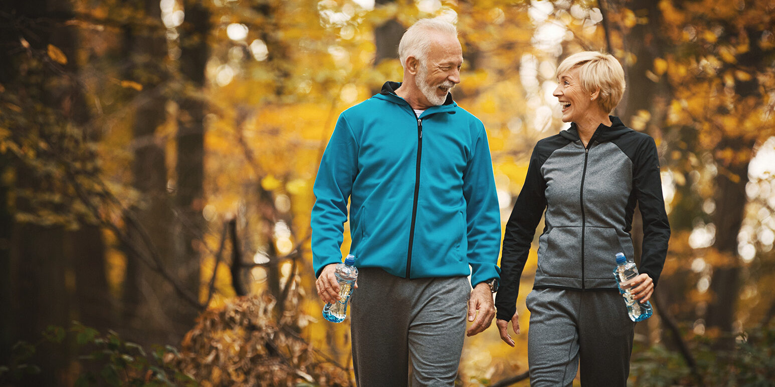 Senior couple walking in a forest.