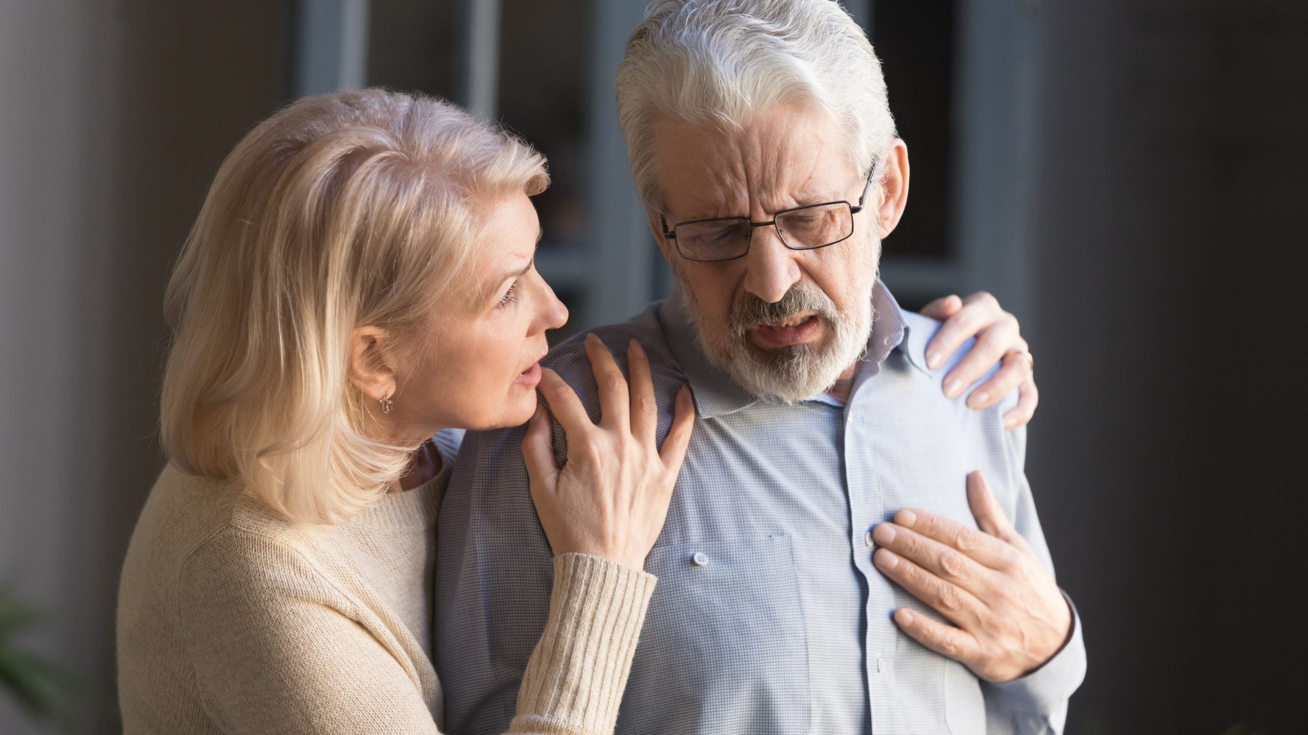You had a heart attack – now what Man grabbing his chest and woman comforting him