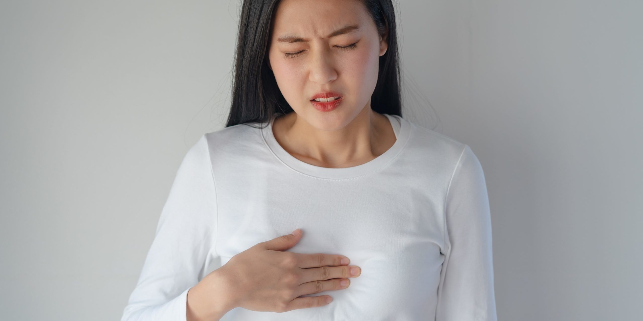 Woman with acid reflux pain
