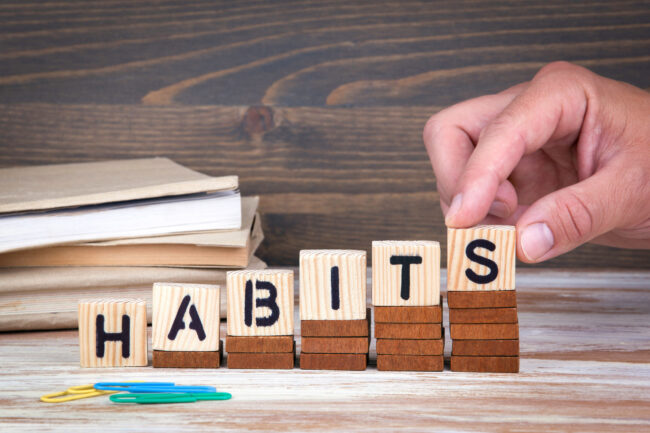 Habits concept. Wooden letters on the office desk, informative a