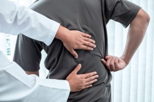 Examining a patient with back pain