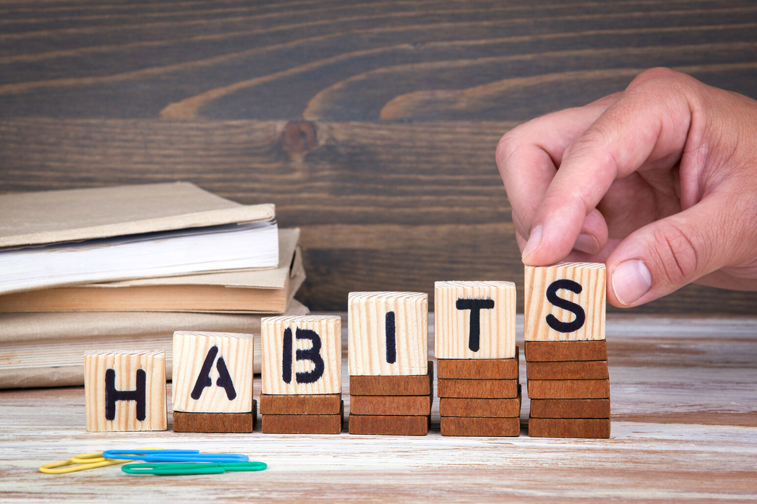 Habits concept. Wooden letters on the office desk, informative a