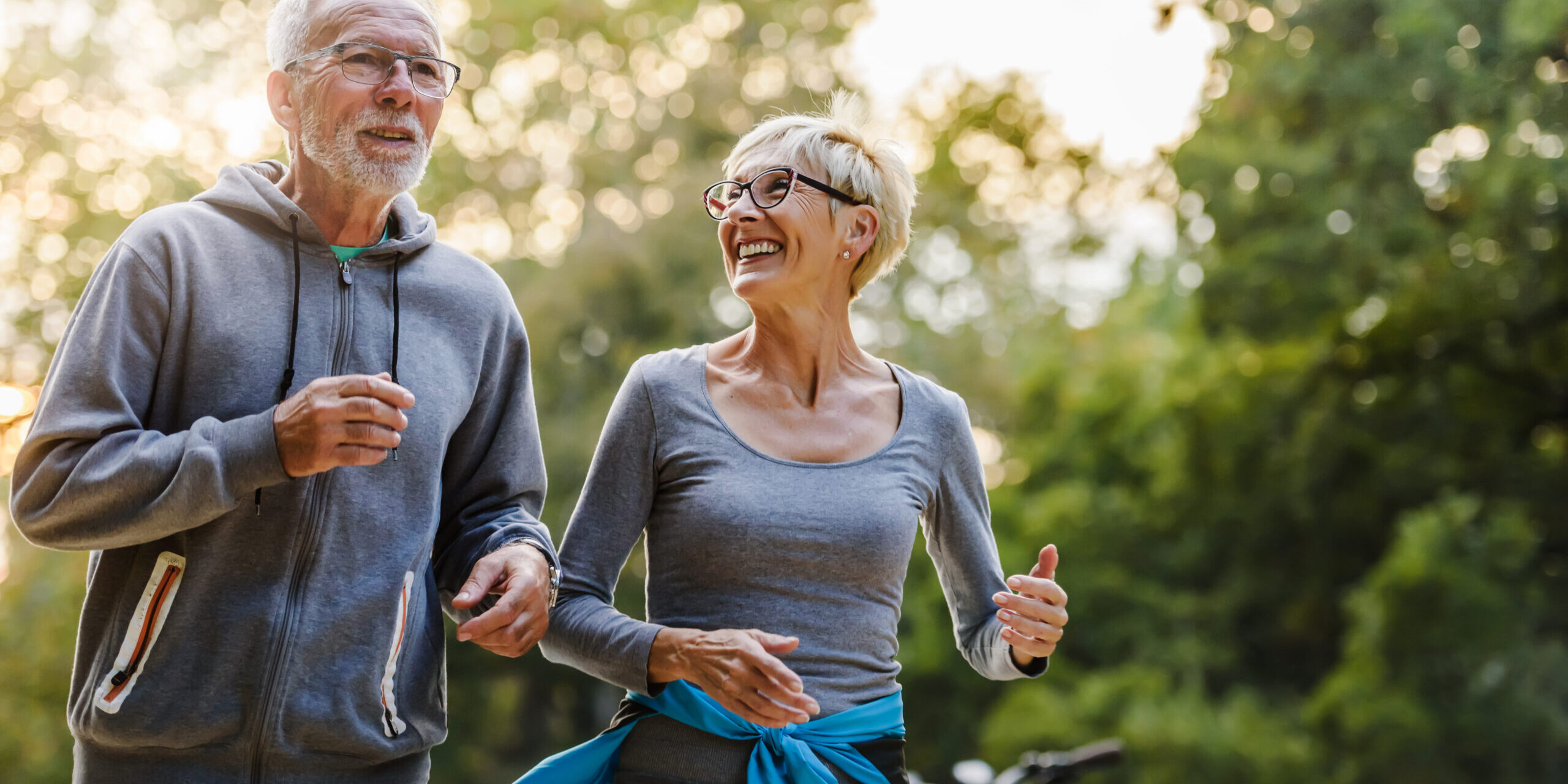 Smiling senior couple jogging in the park