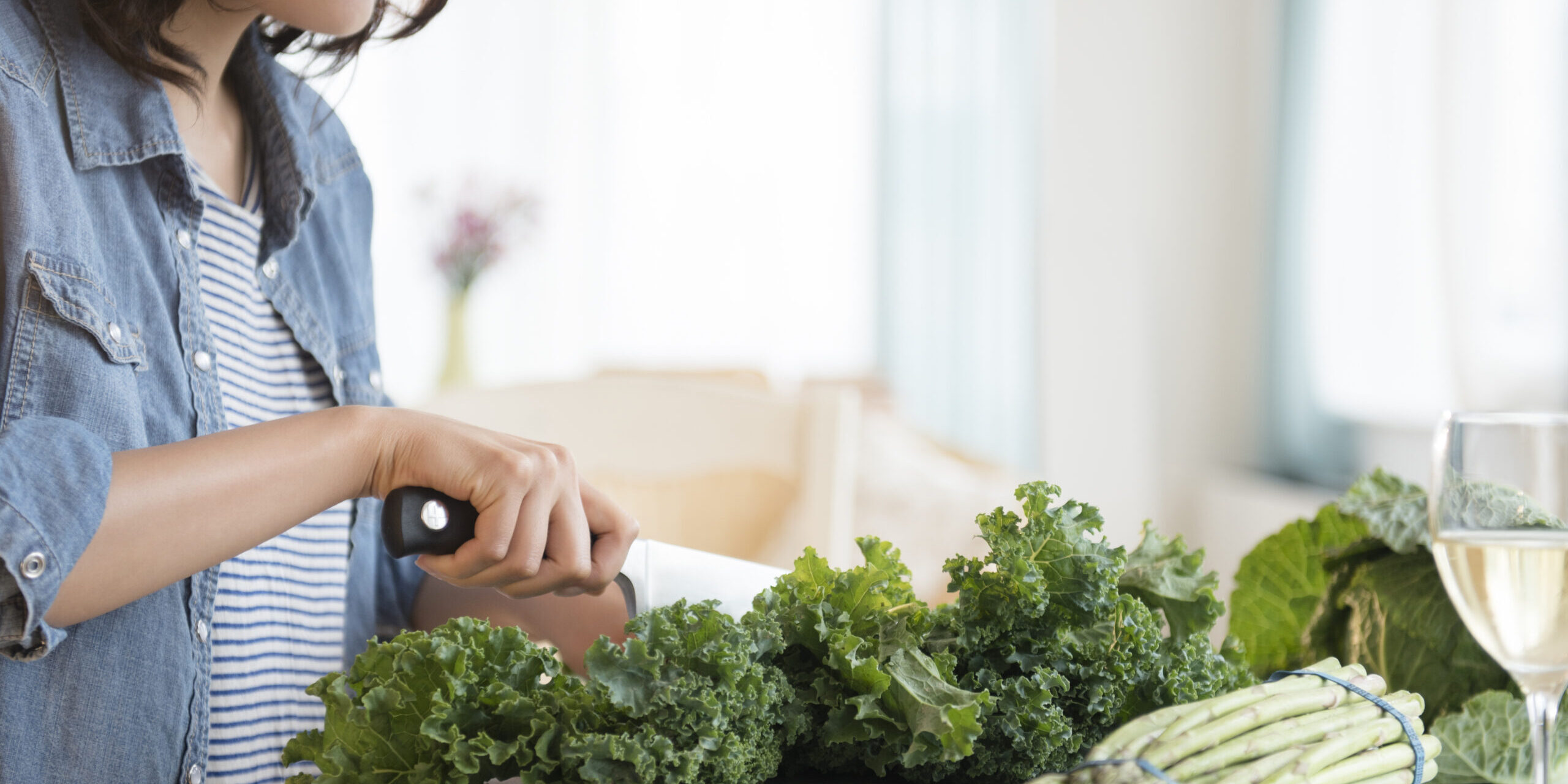 Hispanic woman chopping salad greens